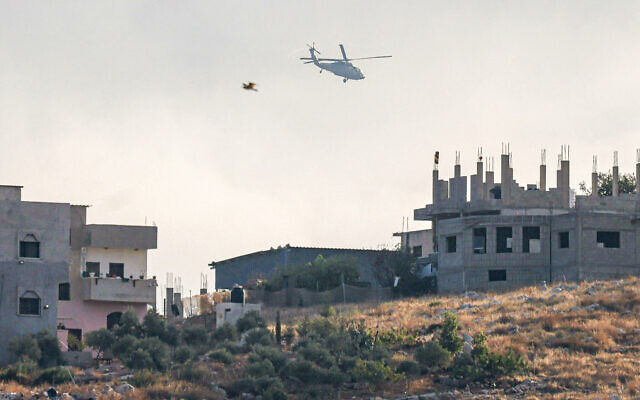 Illustrative: An Israeli military helicopter flies overhead during a raid at the al-Faraa camp north of Nablus in the West Bank on October 10, 2024. (JAAFAR ASHTIYEH / AFP) Illustrative: An Israeli military helicopter flies overhead during a raid at the al-Faraa camp north of Nablus in the West Bank on October 10, 2024. (JAAFAR ASHTIYEH / AFP)