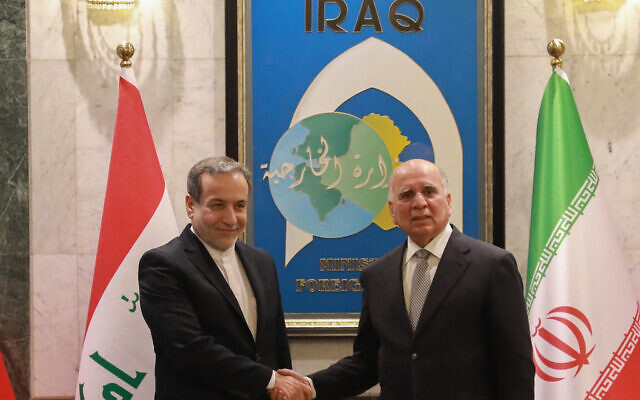 Iraqi Foreign Minister Fuad Hussein (R) welcomes his Iranian counterpart Seyed Abbas Araghchi in Baghdad on October 13, 2024. (Murtaja LATEEF / AFP) Iraqi Foreign Minister Fuad Hussein (R) welcomes his Iranian counterpart Seyed Abbas Araghchi in Baghdad on October 13, 2024. (Murtaja LATEEF / AFP)