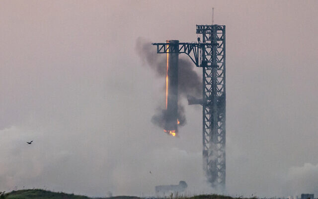 Starship's Super Heavy Booster is grappled at the launch pad in Starbase near Boca Chica, Texas, on October 13, 2024, during the Starship Flight 5 test. (SERGIO FLORES / AFP) Starship's Super Heavy Booster is grappled at the launch pad in Starbase near Boca Chica, Texas, on October 13, 2024, during the Starship Flight 5 test. (SERGIO FLORES / AFP)