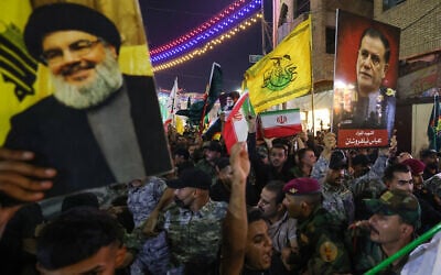 People carry the coffin of Iran's Islamic Revolutionary Guards Corps (IRGC) commander Abbas Nilforoushan during his funeral procession near the Imam Hussein shrine in Iraq's city of Karbala on October 14, 2024. (Ahmad AL-RUBAYE / AFP)