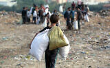 Children sift through waste at a landfill in Khan Yunis in the southern Gaza Strip on October 15, 2024. (Bashar Taleb / AFP)