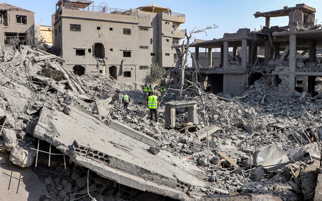 Civil defense members search for survivors through the rubble of a destroyed building at the site of an overnight Israeli airstrike on Kafr Qana in southern Lebanon on October 16, 2024. (Bilal KASHMAR / AFP) Civil defense members search for survivors through the rubble of a destroyed building at the site of an overnight Israeli airstrike on Kafr Qana in southern Lebanon on October 16, 2024. (Bilal KASHMAR / AFP)