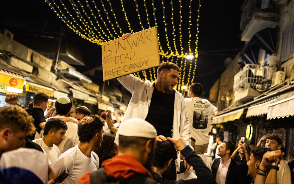 People celebrate in Jerusalem after the IDF confirmed the death of Hamas leader Yahya Sinwar on October 17, 2024. (John Wessels/AFP)