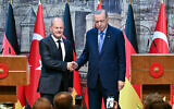 Turkish President Recep Tayyip Erdogan (R) and German Chancellor Olaf Scholz (L) shake hands following a joint press conference after their meeting at the Dolmabahce Presidental Office in Istanbul on October 19, 2024. (Ozan KOSE / AFP)
