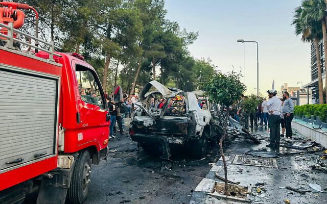 Syrian emergency and security services inspect the wreckage of a car that exploded in Damascus on October 21, 2024. (Photo by Maher AL MOUNES / AFP) Syrian emergency and security services inspect the wreckage of a car that exploded in Damascus on October 21, 2024. (Photo by Maher AL MOUNES / AFP)