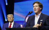 Republican presidential nominee, former US president Donald Trump (left) watches as political commentator Tucker Carlson delivers remarks during a Turning Point Action campaign rally at the Gas South Arena on October 23, 2024, in Duluth, Georgia. (Anna Moneymaker / Getty Images via AFP)