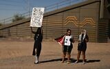 Anti-Israel, pro-Palestinian protesters hold signs as the presidential motorcade of US President Joe Biden drives past near Phoenix, Arizona, on October 25, 2024. (Andrew Caballero-Reynolds/AFP)