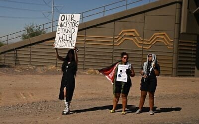 Anti-Israel, pro-Palestinian protesters hold signs as the presidential motorcade of US President Joe Biden drives past near Phoenix, Arizona, on October 25, 2024. (Andrew Caballero-Reynolds/AFP)