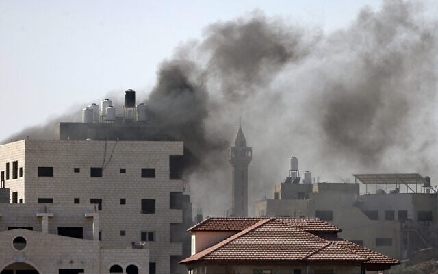 Smoke rises during a reported Israeli raid in Tulkarem in the north of the West Bank on October 26, 2024. (Jaafar Ashtiyeh/AFP) Smoke rises during a reported Israeli raid in Tulkarem in the north of the West Bank on October 26, 2024. (Jaafar Ashtiyeh/AFP)
