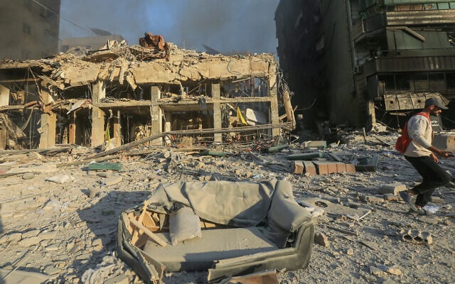A man walks past destroyed and damaged buildings at the site of an overnight Israeli airstrike that targeted Beirut's southern suburbs on October 27, 2024. (AFP) A man walks past destroyed and damaged buildings at the site of an overnight Israeli airstrike that targeted Beirut's southern suburbs on October 27, 2024. (AFP)