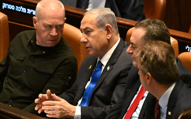 Prime Minister Benjamin Netanyahu (C) speaks to Defense Minister Yoav Gallant (L) at the opening of the Knesset winter session in Jerusalem on October 28, 2024. (Photo by DEBBIE HILL / POOL / AFP) Prime Minister Benjamin Netanyahu (C) speaks to Defense Minister Yoav Gallant (L) at the opening of the Knesset winter session in Jerusalem on October 28, 2024. (Photo by DEBBIE HILL / POOL / AFP)