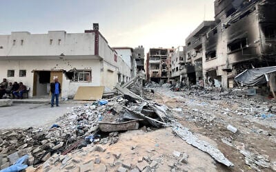 Rubbish and debris are scattered near damaged buildings in the vicinity of the Kamal Adwan hospital in Beit Lahiya in the northern Gaza Strip on October 31, 2024. (AFP)