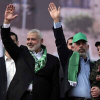 Head of the Hamas political bureau, Ismail Haniyeh (left) and Hamas leader in the Gaza Strip Yahya Sinwar (right) at a rally marking the 30th anniversary of the terror group, in Gaza City, December 14, 2017. (AP Photo/ Khalil Hamra)