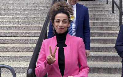 Masih Alinejad, an outspoken US-based opponent of Iran's Islamist regime, flashes a v-sign as she leaves a federal courthouse in Manhattan, New York, April 7, 2023. (AP Photo/Lawrence Neumeister)