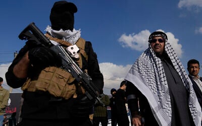 Members of an Iraqi Shiite militant group attend the funeral of a fighter with the Kataeb Hezbollah terror militia who was killed in a US airstrike, in Baghdad, Iraq, January 25, 2024. (AP Photo/Hadi Mizban)