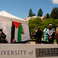 A sign is shown written over to read 'University of Palestine' at an anti-Israel encampment on the University of Washington campus April 29, 2024, in Seattle. (AP Photo/Lindsey Wasson)