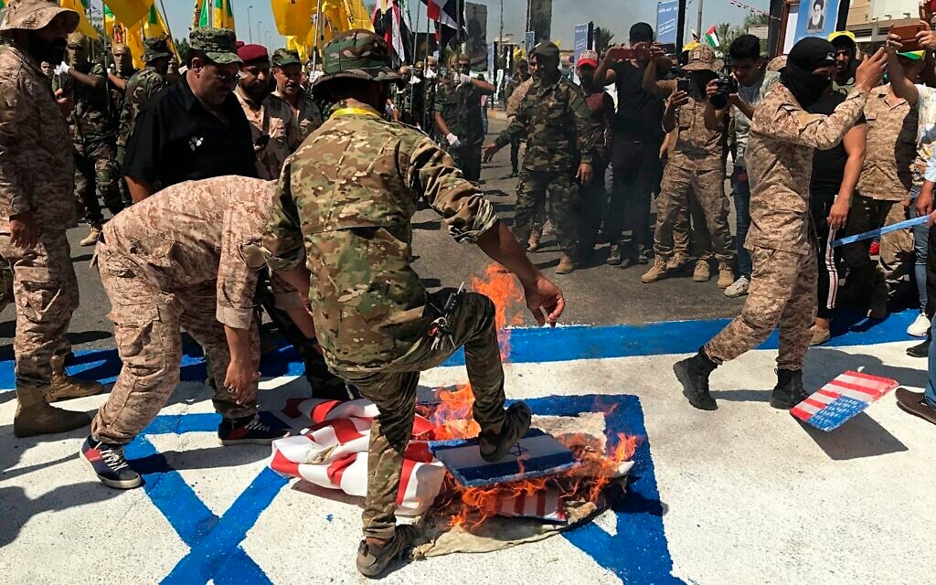 Popular Mobilization Forces burn representations of US and Israeli flags during al-Quds Day in Baghdad, Iraq, May 31, 2019. (AP Photo/Ali Abdul Hassan, File) Popular Mobilization Forces burn representations of US and Israeli flags during al-Quds Day in Baghdad, Iraq, May 31, 2019. (AP Photo/Ali Abdul Hassan, File)