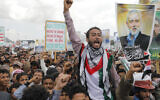 Houthi supporters hold posters showing Ismail Haniyeh, the Hamas leader assassinated in Tehran during an anti-Israel and anti-American rally in Sanaa, Yemen, August 16, 2024. (AP Photo/Osamah Abdulrahman)