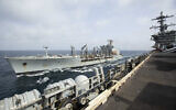 This handout photo from the US Navy shows the Henry J. Kaiser-class fleet replenishment oiler USNS Big Horn sailing alongside the aircraft carrier USS Abraham Lincoln on September 11, 2024, at an undisclosed location at sea in the Middle East. (US Navy via AP)