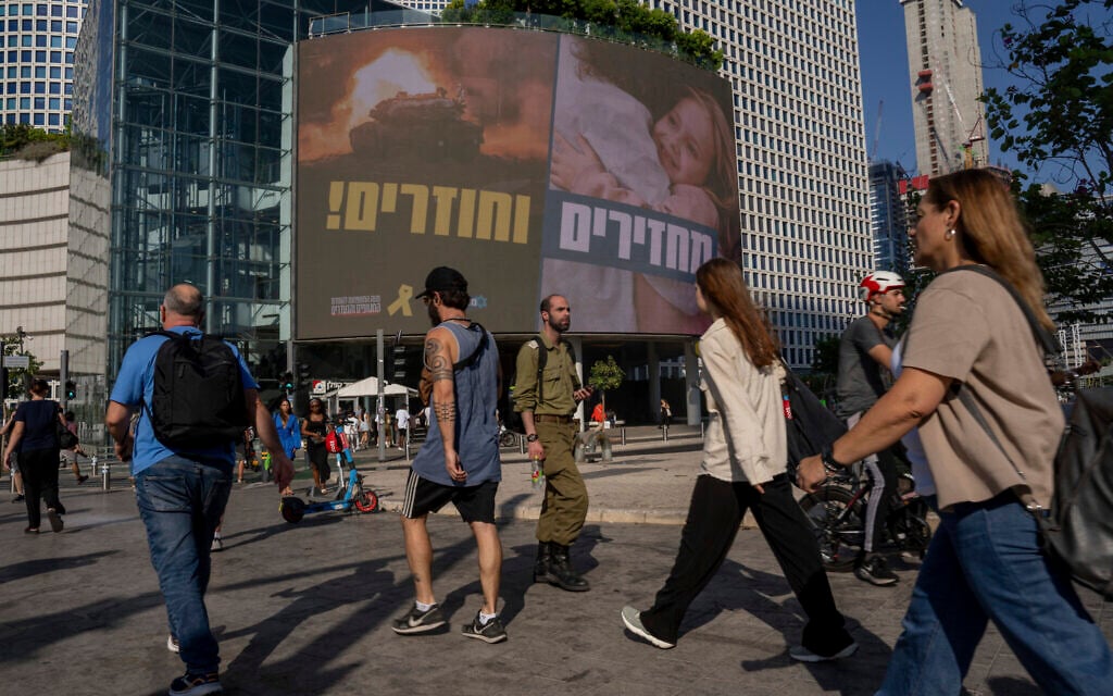 People pass by a sign calling for the release of hostages held in the Gaza Strip by Hamas for nearly a year, in Tel Aviv, Israel, Monday, Sept. 10, 2024. (AP Photo/Ohad Zwigenberg) People pass by a sign calling for the release of hostages held in the Gaza Strip by Hamas for nearly a year, in Tel Aviv, Israel, Monday, Sept. 10, 2024. (AP Photo/Ohad Zwigenberg)