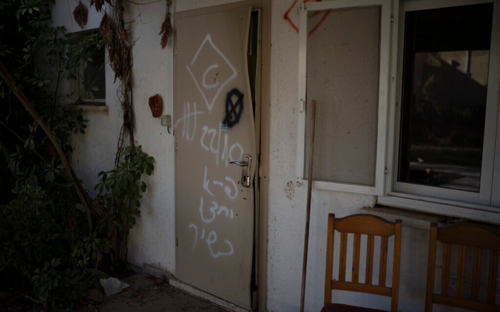 The front door of the home of Shlomo Margalit and Hanna’le Margalit that was damaged by Hamas terrorists in the attack on Kibbutz Nir Oz during the October 7 onslaught, seen on September 26, 2024. (AP Photo/Leo Correa)