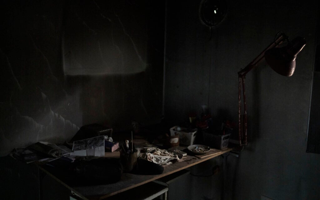A desk that was damaged during Hamas's October 7 onslaught is seen in the safe room of Liat Atzili’s house at Kibbutz Nir Oz, September 26, 2024. (AP Photo/Leo Correa)