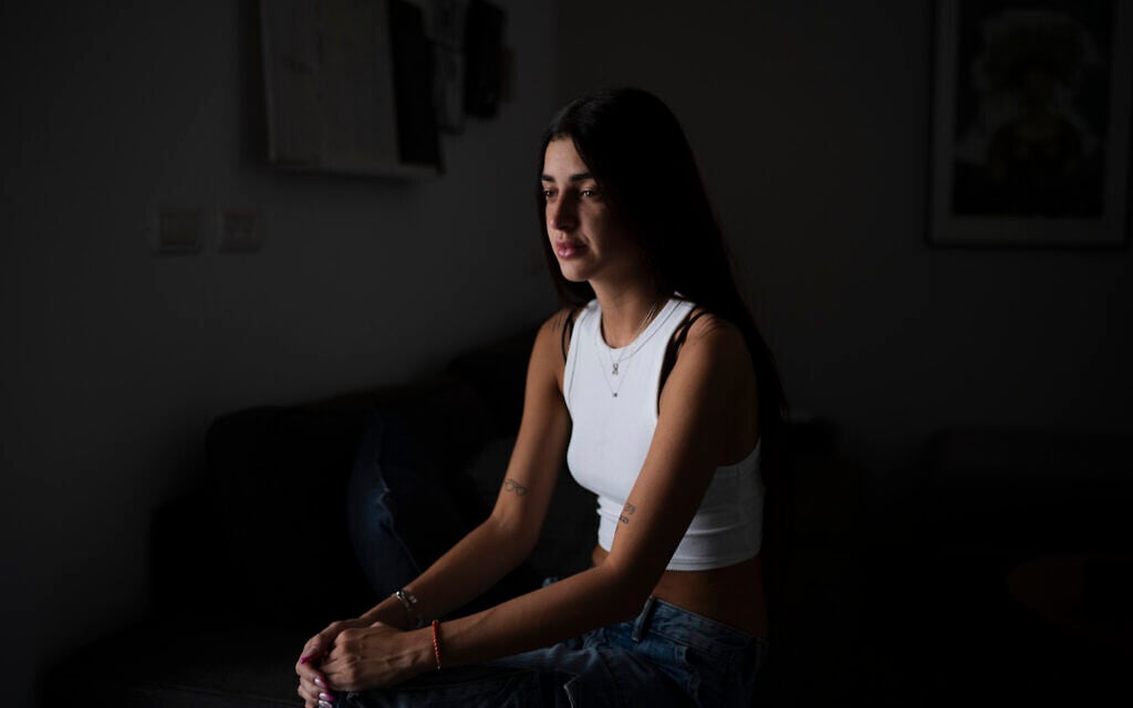 Ziv Abud talks about the Hamas attack on the Nova music festival on October 7, 2023, during an interview at her house in Tel Aviv, September 19, 2024. (AP Photo/Leo Correa)
