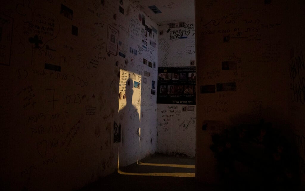 A man casts a shadow on the wall as he enters the roadside bomb shelter where Ziv Abud survived, protected by the crush of bodies above her, during the Hamas attack on October 7, 2023, near Kibbutz Reim, seen on September 26, 2024. (AP Photo/Leo Correa)