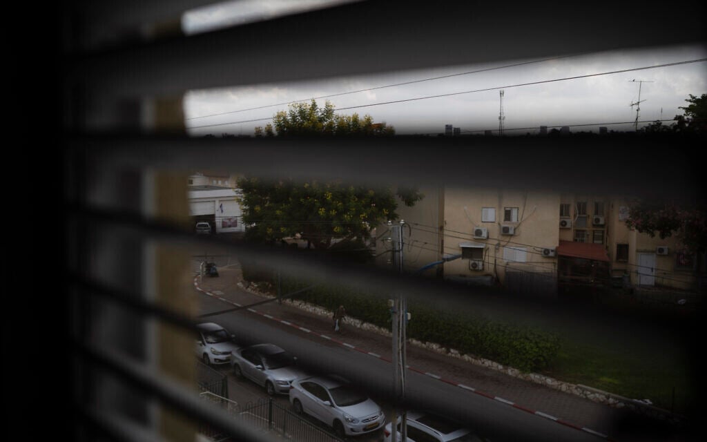 An member of the security forces walks down a street near a police station destroyed during the Hamas attack on Sderot on October 7, 2023, as seen from the bedroom window of Lilach Almog's apartment on September 22, 2024. (AP Photo/Leo Correa)