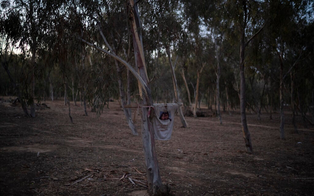 A T-shirt commemorating the couple Antonio Yaniv Macías Montano and Yvonne Eden Patricia Rubio Vargas hangs on a tree at the site where revelers were killed and kidnapped during the Hamas attack on the Kibbutz Reim-area Nova music festival on October 7, 2023, seen on September 27, 2024. (AP Photo/Leo Correa)