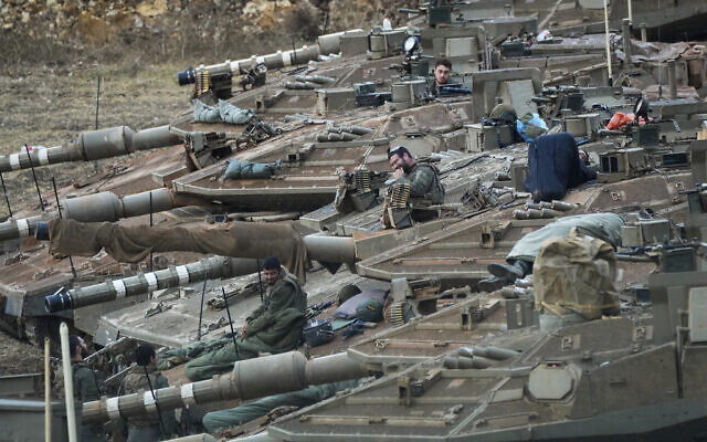 Israeli soldiers work on tanks in a staging area in northern Israel near the Israel-Lebanon border, October 1, 2024. (AP/Baz Ratner) Israeli soldiers work on tanks in a staging area in northern Israel near the Israel-Lebanon border, October 1, 2024. (AP/Baz Ratner)
