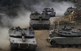 Israeli armored vehicles seen in a staging area in northern Israel near the Israel-Lebanon border, October 1, 2024. (AP/Baz Ratner)