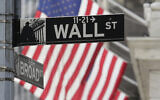 Signs marking the intersection of Broad and Walls Streets stand near the New York Stock Exchange on Tuesday, October 1, 2024, in New York. (AP Photo/Peter Morgan)