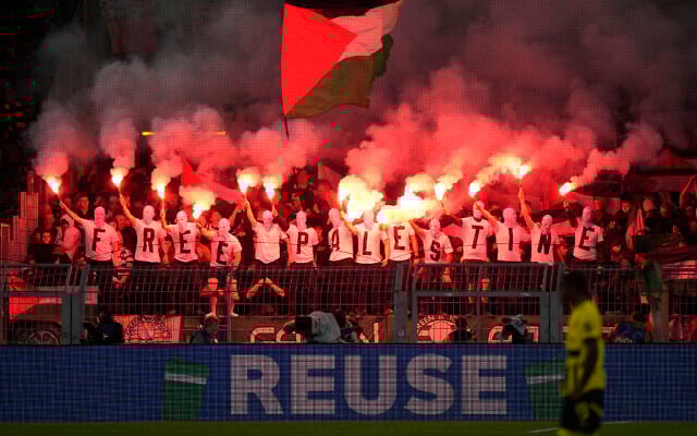 Celtic fans waving a Palestinian flag hold smoke flares during the Champions League opening phase soccer match between Borussia Dortmund and Celtic FC at the BVB Stadion in Dortmund, Germany, Tuesday, Oct. 1, 2024. (AP Photo/Martin Meissner) Celtic fans waving a Palestinian flag hold smoke flares during the Champions League opening phase soccer match between Borussia Dortmund and Celtic FC at the BVB Stadion in Dortmund, Germany, Tuesday, Oct. 1, 2024. (AP Photo/Martin Meissner)