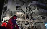 A firefighter stands in front of an apartment hit by an Israeli airstrike, in Beirut, Lebanon, October 3, 2024. (AP Photo/Hussein Malla)