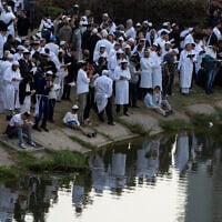 Orthodox Jews pray near the lake at the tomb of Rabbi Nachman, the great grandson of the founder of Hasidic movement, in the town of Uman, Ukraine, October 3, 2024. (AP Photo/Efrem Lukatsky)