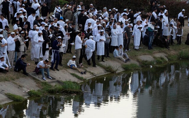 Orthodox Jews pray near the lake at the tomb of Rabbi Nachman, the great grandson of the founder of Hasidic movement, in the town of Uman, Ukraine, Thursday, Oct. 3, 2024. (AP Photo/Efrem Lukatsky) Orthodox Jews pray near the lake at the tomb of Rabbi Nachman, the great grandson of the founder of Hasidic movement, in the town of Uman, Ukraine, Thursday, Oct. 3, 2024. (AP Photo/Efrem Lukatsky)