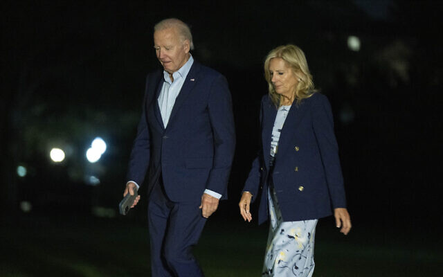 US President Joe Biden and first lady Jill Biden walk on the South Lawn as they arrive on Marine One at the White House from Camp David, Sunday, Oct. 6, 2024, in Washington. (AP Photo/Manuel Balce Ceneta)