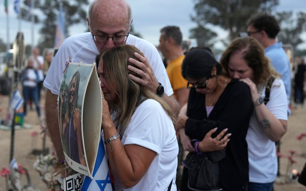 People visit the site of the Nova music festival, where hundreds of revelers were killed and abducted by Hamas and taken into Gaza, on the one-year anniversary of the attack, near Kibbutz Reim, southern Israel, Monday, Oct. 7, 2024. (AP Photo/Ariel Shalit)