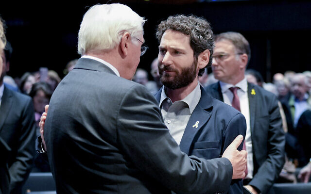 German President Frank-Walter Steinmeier left, talks to Hamas attack survivor Alon Gat, right, during an official commemoration ceremony in the Kaiser Wilhelm memorial church in Berlin, Germany, October 7, 2024, marking the first anniversary of the Oct. 7, 2023 Hamas terror attacks on Israel. (Markus Schreiber/AP) German President Frank-Walter Steinmeier left, talks to Hamas attack survivor Alon Gat, right, during an official commemoration ceremony in the Kaiser Wilhelm memorial church in Berlin, Germany, October 7, 2024, marking the first anniversary of the Oct. 7, 2023 Hamas terror attacks on Israel. (Markus Schreiber/AP)