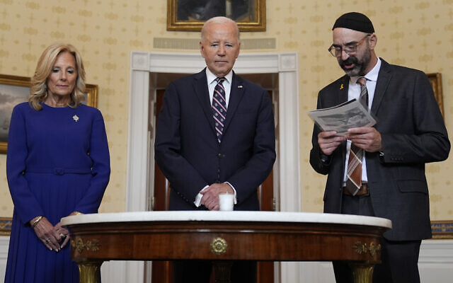 US President Joe Biden, center, standing with first lady Jill Biden, left, and Rabbi Aaron Alexander of the Adas Israel Congregation, participates in a memorial candle-lighting in the Blue Room of the White House in Washington, October 7, 2024, to mark the one-year anniversary of the Hamas terror attack on Israel that killed 1,200 people. (Susan Walsh/AP) US President Joe Biden, center, standing with first lady Jill Biden, left, and Rabbi Aaron Alexander of the Adas Israel Congregation, participates in a memorial candle-lighting in the Blue Room of the White House in Washington, October 7, 2024, to mark the one-year anniversary of the Hamas terror attack on Israel that killed 1,200 people. (Susan Walsh/AP)