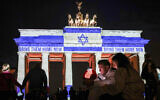 The Brandenburg Gate is illuminated with the flag of Israel in Berlin, Germany, October 7, 2024, to mark the one-year anniversary of Hamas's October 7 massacre in Israel. (Kay Nietfeld/dpa via AP)