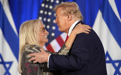 Republican presidential nominee Donald Trump embraces Miriam Adelson at an event marking one year since the October 7 Hamas attack on Israel, October 7, 2024, in Miami. (AP Photo/Alex Brandon)