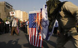 Iranian demonstrators burn representations of the Israeli and US flags during an anti-Israel gathering in Tehran, Iran, Tuesday, October 8, 2024. (AP/Vahid Salemi)
