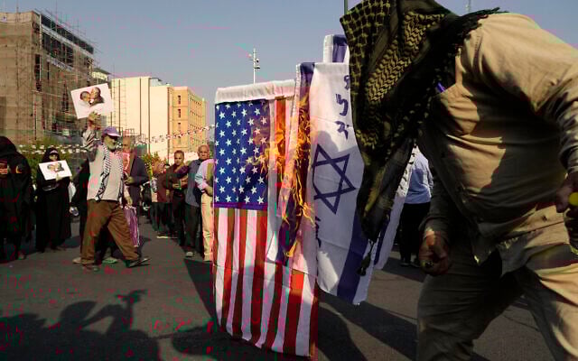 Iranian demonstrators burn representations of the Israeli and US flags during an anti-Israel gathering in Tehran, Iran, Tuesday, October 8, 2024. (AP/Vahid Salemi) Iranian demonstrators burn representations of the Israeli and US flags during an anti-Israel gathering in Tehran, Iran, Tuesday, October 8, 2024. (AP/Vahid Salemi)