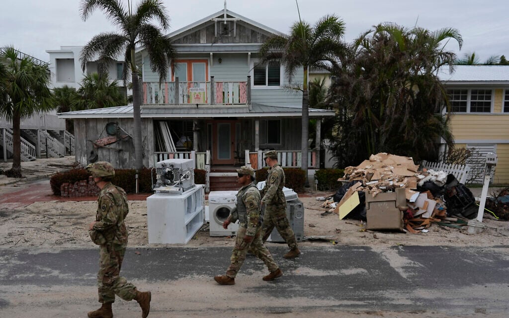 Illustrative: Members of the Florida Army National Guard check for any remaining residents in nearly deserted Bradenton Beach, where piles of debris from Hurricane Helene flooding still sits outside damaged homes ahead of the arrival of Hurricane Milton, October 8, 2024, on Anna Maria Island, Florida. (AP Photo/Rebecca Blackwell) Illustrative: Members of the Florida Army National Guard check for any remaining residents in nearly deserted Bradenton Beach, where piles of debris from Hurricane Helene flooding still sits outside damaged homes ahead of the arrival of Hurricane Milton, October 8, 2024, on Anna Maria Island, Florida. (AP Photo/Rebecca Blackwell)