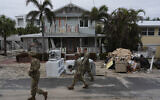 Illustrative: Members of the Florida Army National Guard check for any remaining residents in nearly deserted Bradenton Beach, where piles of debris from Hurricane Helene flooding still sits outside damaged homes ahead of the arrival of Hurricane Milton, October 8, 2024, on Anna Maria Island, Florida. (AP Photo/Rebecca Blackwell)