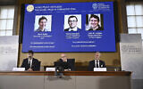Johan Åqvist, member of the Nobel Committee for Chemistry, Hans Ellegren, Permanent Secretary and Heiner Linke, Chairman of the Nobel Committee for Chemistry award this years Nobel Prize in Chemistry to David Baker, Demis Hassabis, and John M Jumper at the Royal Swedish Academy of Sciences, in Stockholm, Sweden, October 9, 2024. (Christine Olsson/TT News Agency via AP)