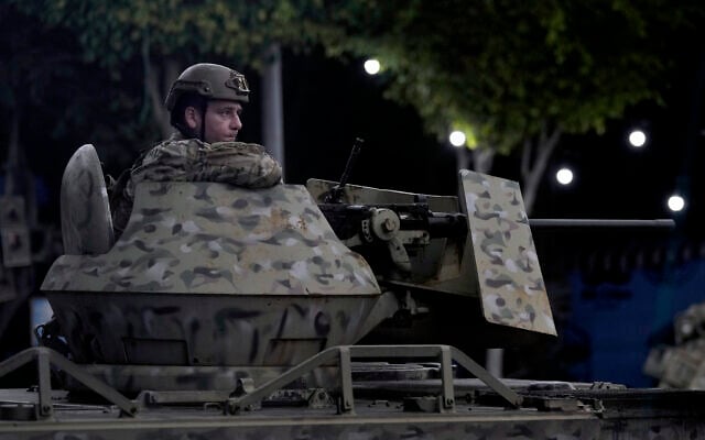 A Lebanese army soldier sits behind his weapon on the top of an armored personnel carrier at the site of an Israeli airstrike in Beirut's southern suburb, September 23, 2024. (AP Photo/Bilal Hussein, File) A Lebanese army soldier sits behind his weapon on the top of an armored personnel carrier at the site of an Israeli airstrike in Beirut's southern suburb, September 23, 2024. (AP Photo/Bilal Hussein, File)