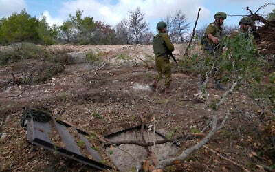 IDF soldiers display an entrance to a Hezbollah tunnel found during their ground operation in southern Lebanon, near the border with Israel, October 13, 2024. (AP Photo/Sam McNeil)
